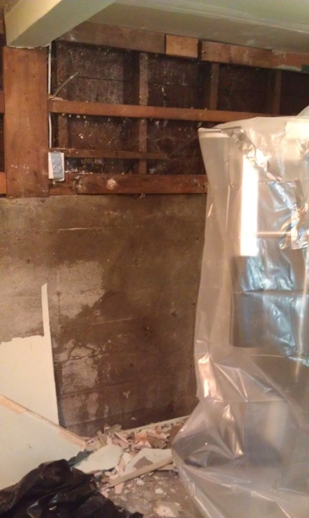 The dark stain on the wall is where the water runs down from the hole